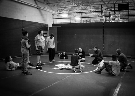 Wrestlers circle up during practice