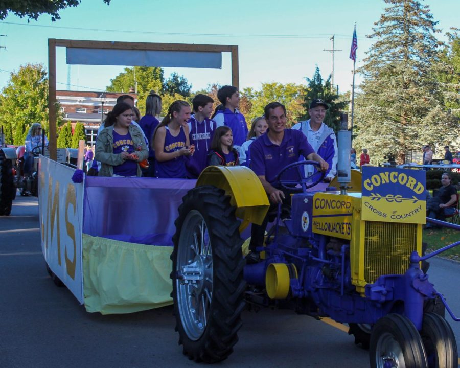 Coach Jordon pulls XC runners with his brightly painted tractor. 