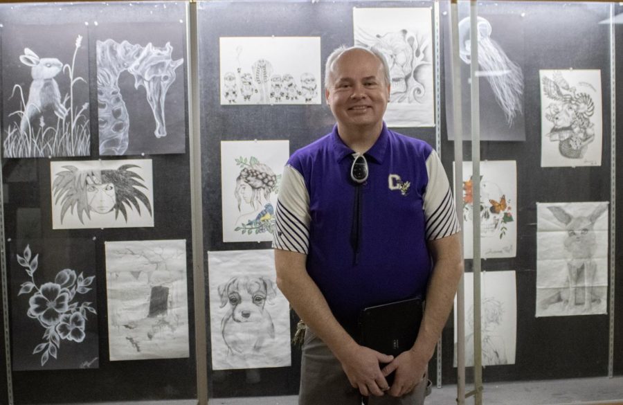 Couling in front of all the great artwork in the showcase.