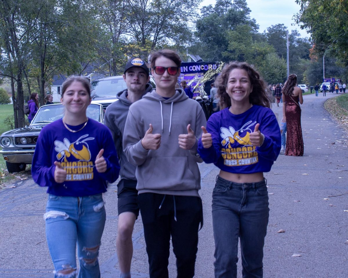 Riley Adams, Manix Furqueron, Andrew Uncapher, and Gwendolyn Bulko enjoying their time at the start of the parade