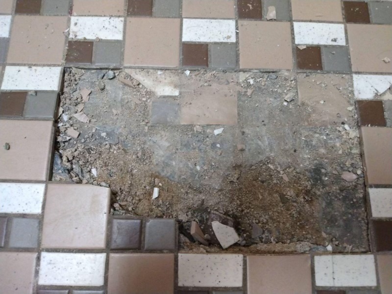 Floor broken by students in the boys bathroom. 

Courtesy of Bob Vandenburgh 