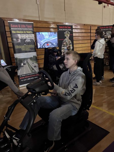 Landen Lynn partaking in the distracted driving simulator.