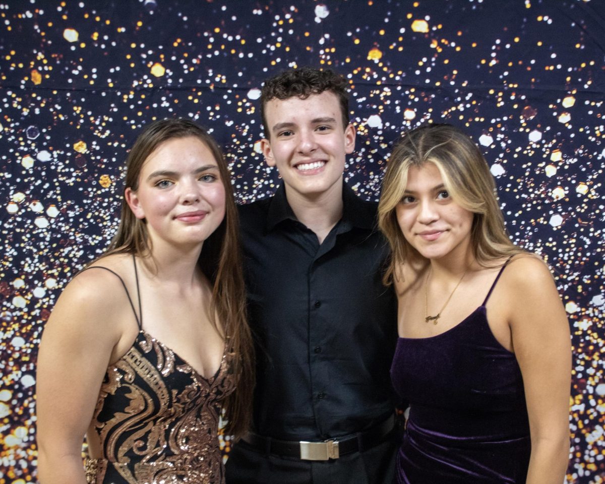 Lily McCabe, Bernardo Boniati, and Lily Helms at the homecoming dance 