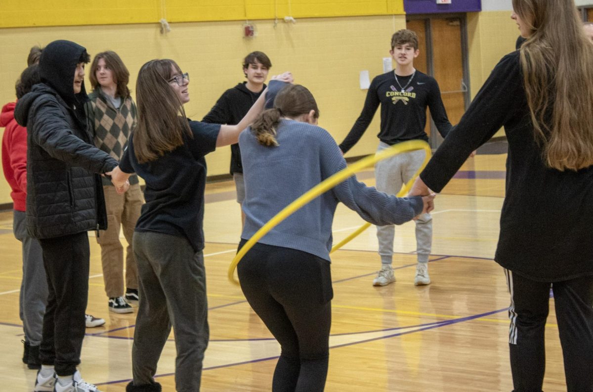 The junior class competing in Hula Hoop Pass through.