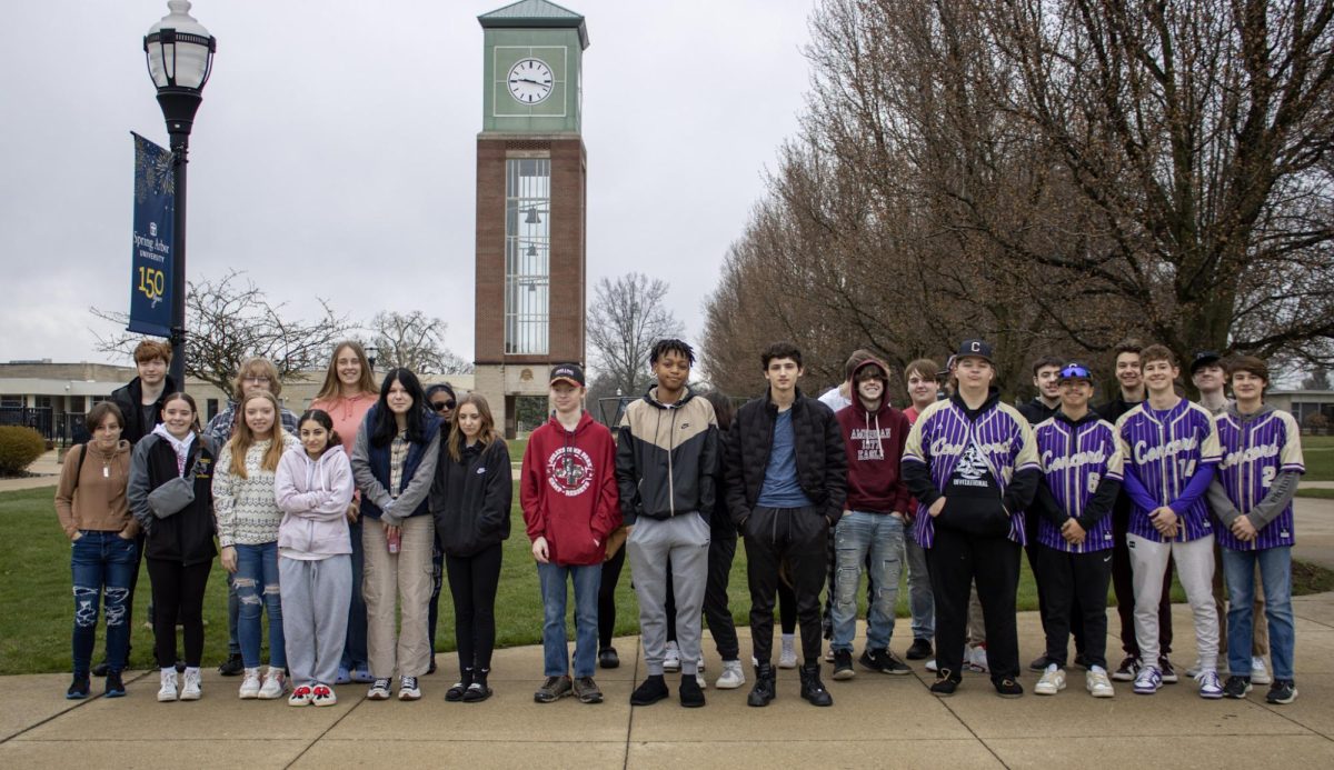 The Juniors posing in front of the clock tower in Spring Arbor College