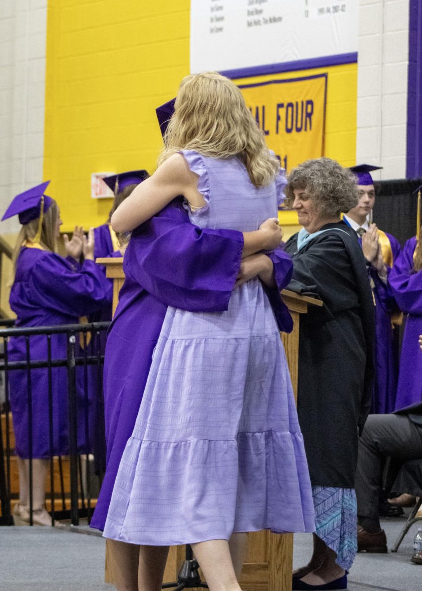Ella Woolworth giving a hug to her mom after receiving her diploma.