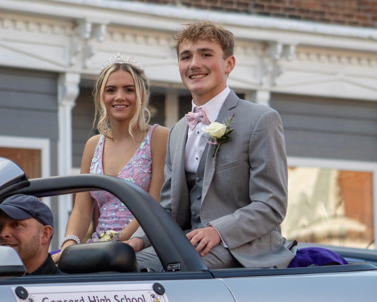 Freshman homecoming representives, Hunter Watts, and Addison Riske, happily going through the parade