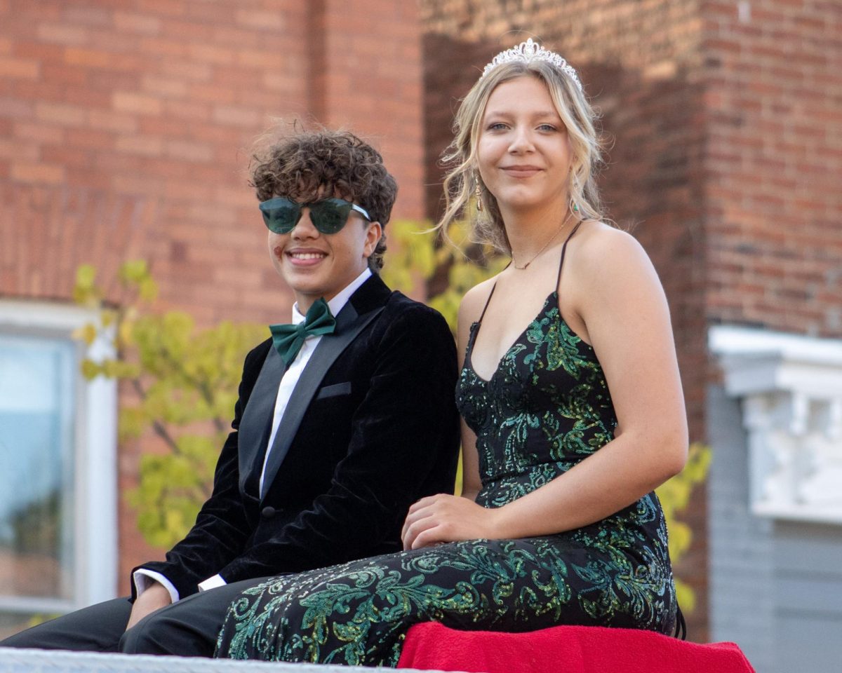 Sophomore Homecoming representatives Eli Krieger, and Avery Arbuckle going through the parade