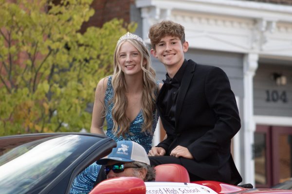 Senior homecoming candidates, Ilya weeks, and Dustin hamilton proudly going through the parade