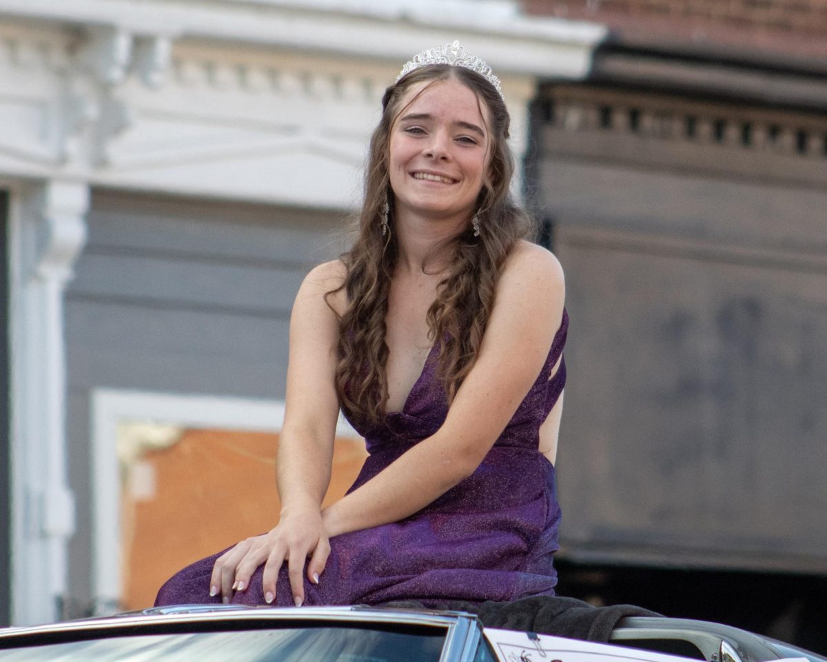 Homecoming queen candidate, Hannah Stimer, proudly riding through the parade