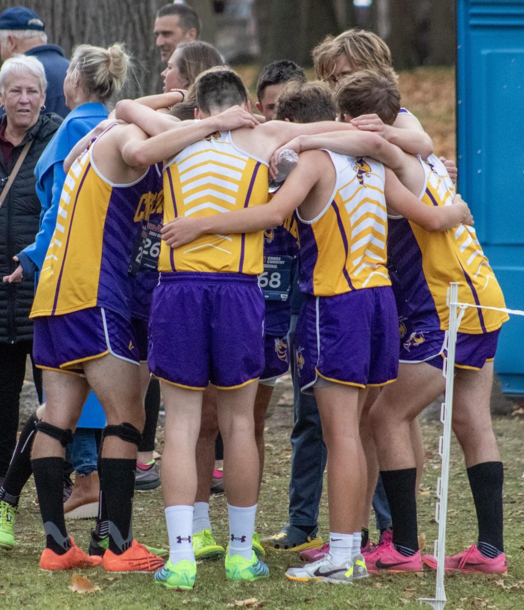 Boys Cross country team huddled up after the race