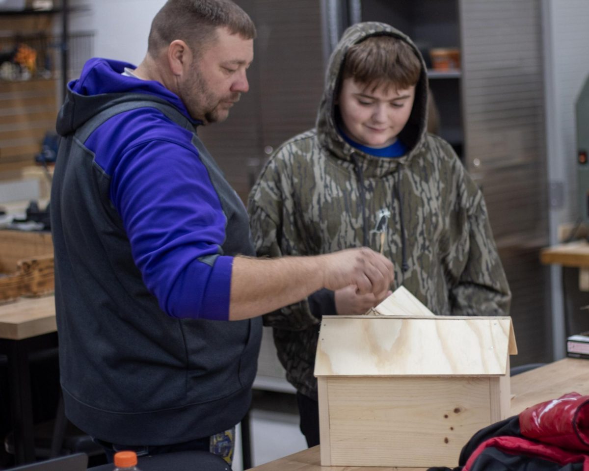 Mike Arbuckle helping  Ty Sinden build