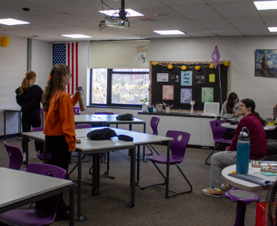 Some of Ms. Kelly's students enter the classroom at the beginning of seminar.