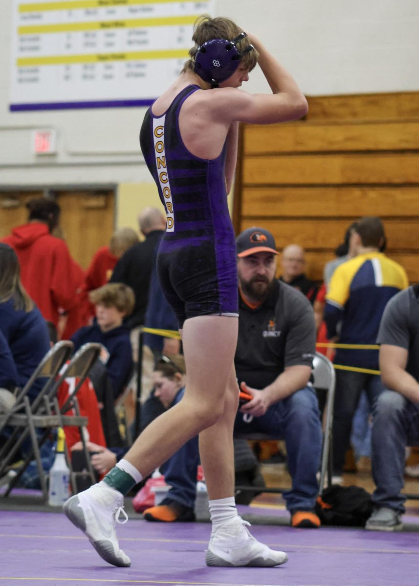 Nate taking off his gear after completing all of his matches.