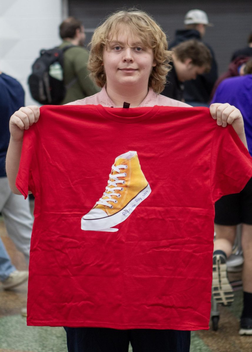 Jayden Carpenter-Sattler holding the shirt each senior was gifted in the gift bags.