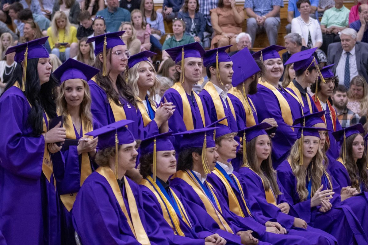 Seniors standing to walk onto the stage.