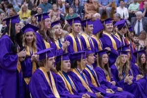 Seniors standing to walk onto the stage.