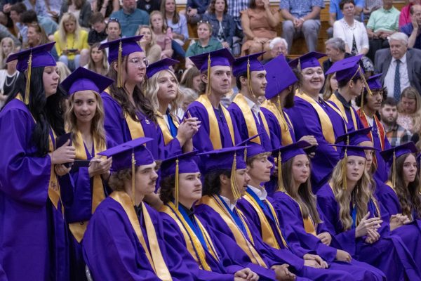Seniors standing to walk onto the stage.