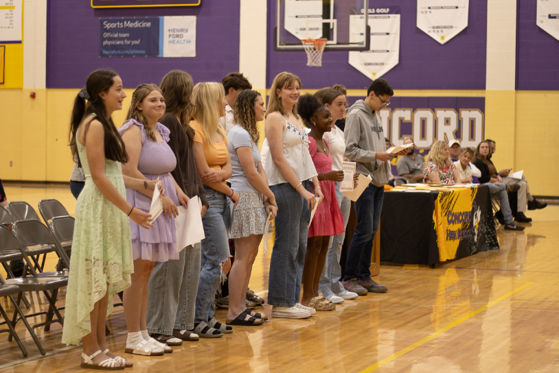 Freshman admiring their awards.  