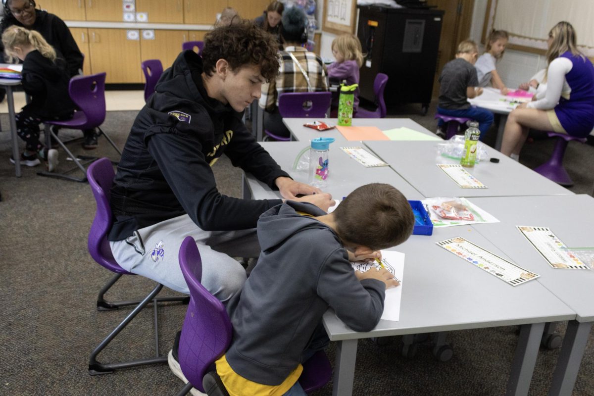 Tyler Rundle helping make signs with the kindergarten class.