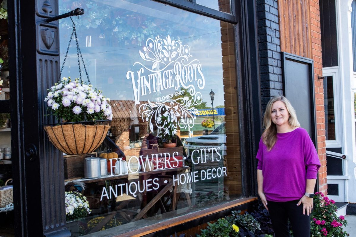 Brianne Sinden posing in front of her shop.