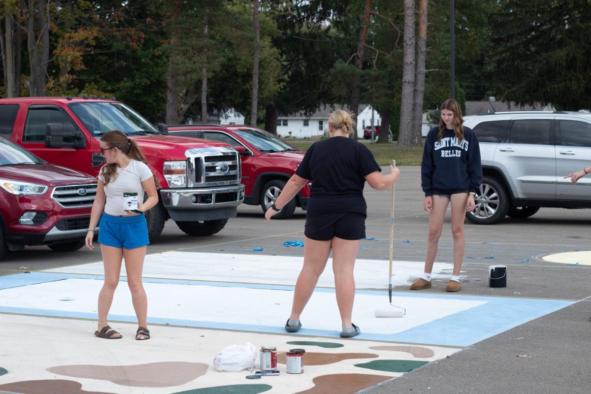 Macy Sinden, Bella Coppernoll, and Julia Stevens expressing their imagination through their parking spot painting.
