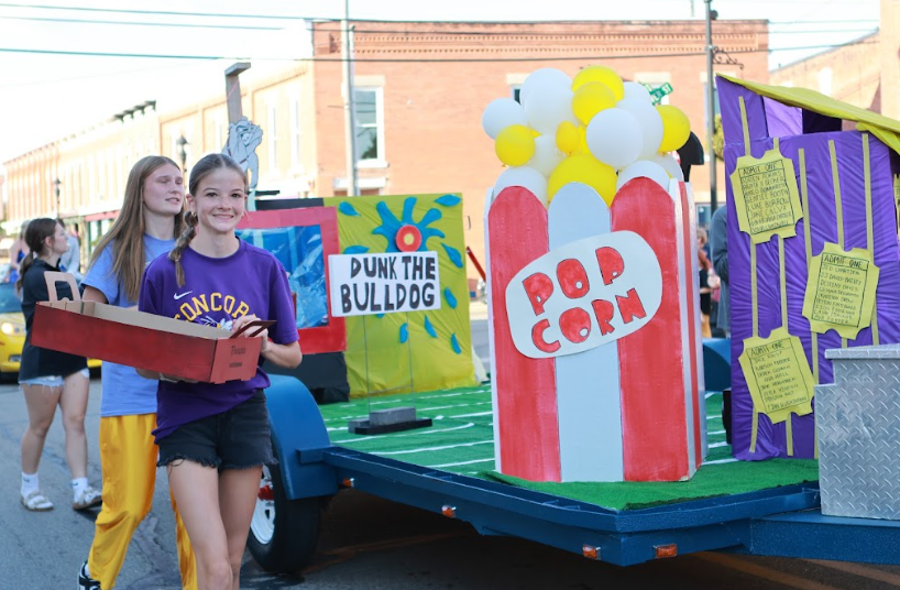 Audrey Pyle throwing candy by Freshman Float