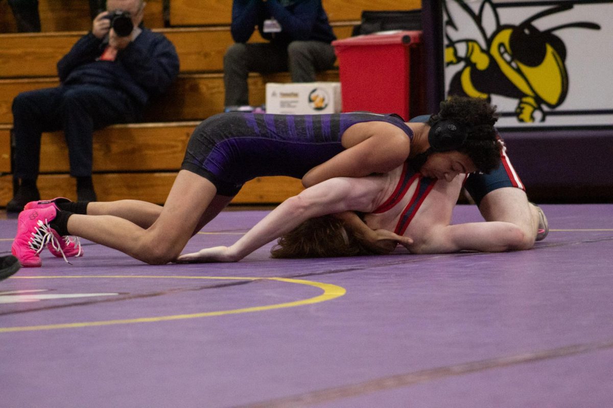 Zion Eddings attempting to pin an opponent. 