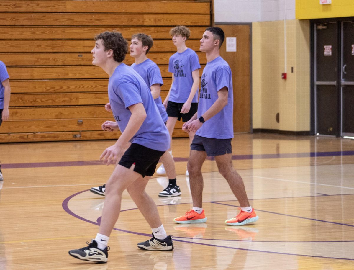 Junior boys on the court awaiting the next serve