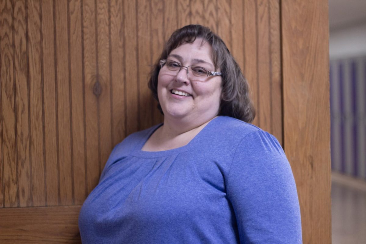 Amy Korman posing for a picture outside classroom.