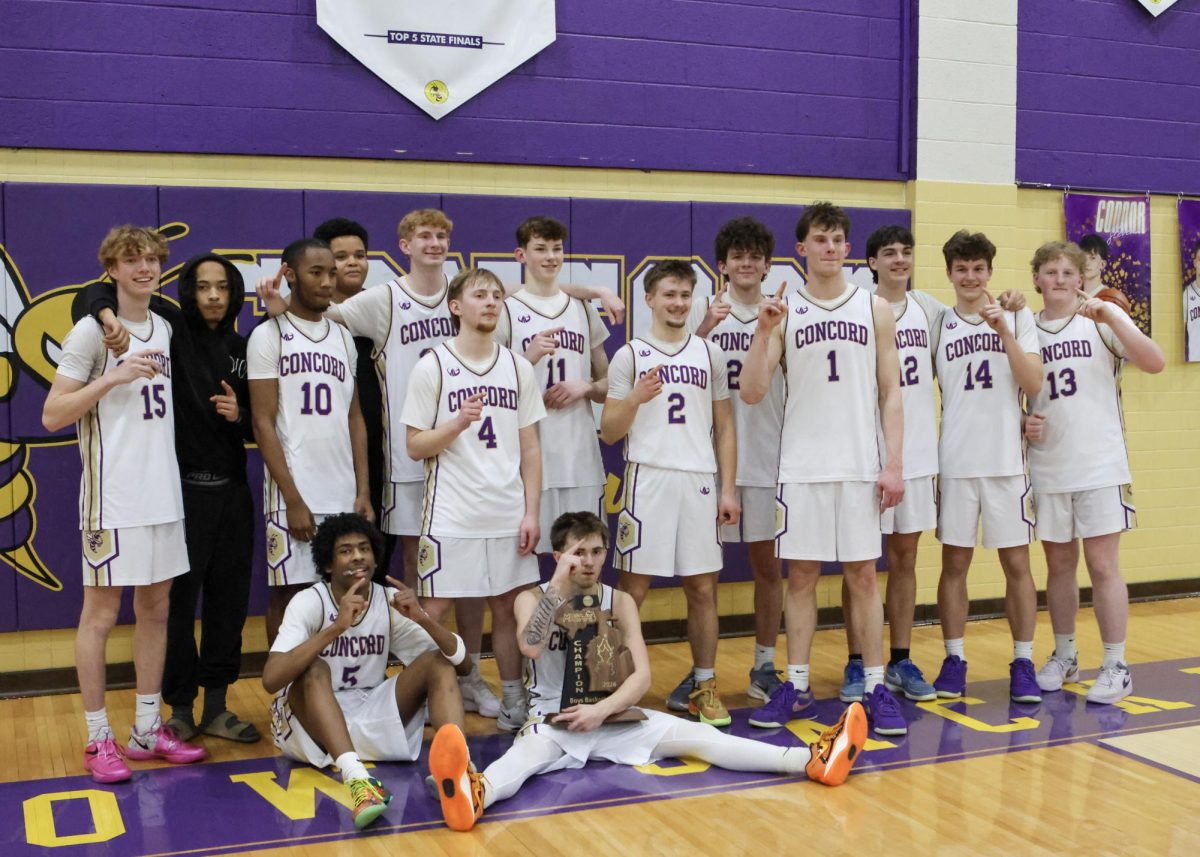 Our 2026 Varsity Basketball Regional Championship team proudly displaying their trophy as their fans cheer them on. 