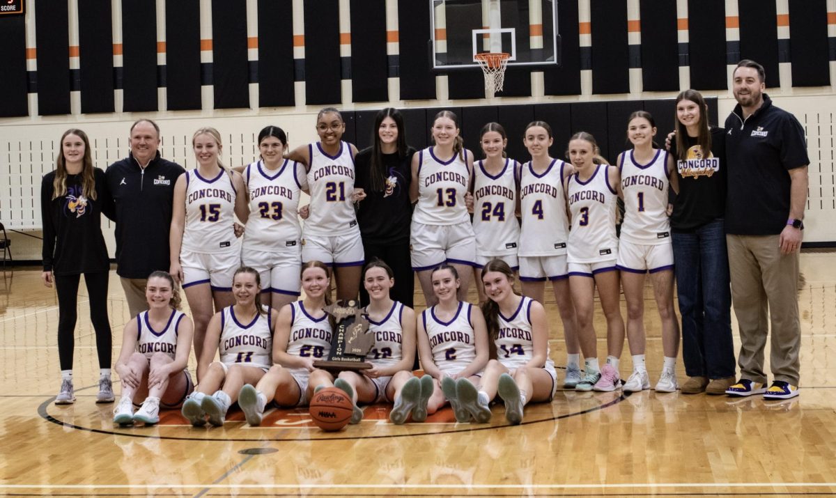The girls basketball team posing for a picture after winning against a strong defensive Hillsdale team and becoming Regional champs.