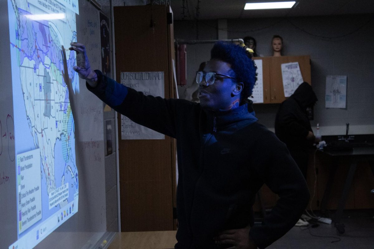 Junior Jeff Thomas explains weather patterns in his 7th hour class.