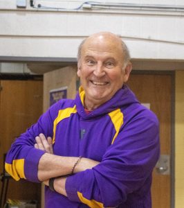 Beloved coach and teacher Mike Jurasek posing enthusiastically.