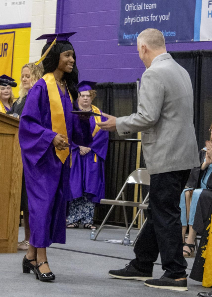 Saniya Newton walking the stage and receiving her diploma.