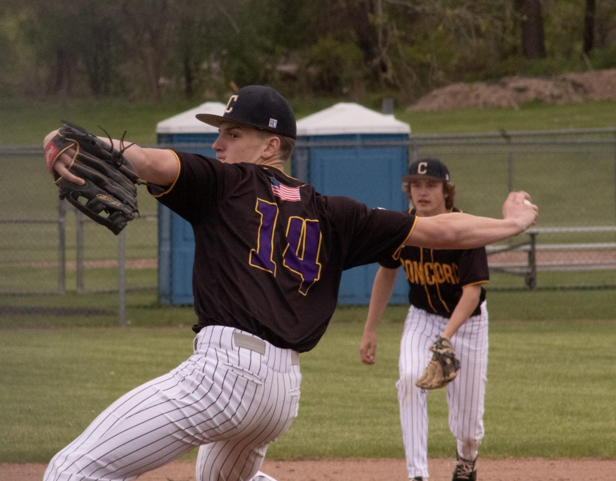 Wyatt Mandrelle pitching while Nate Fritz gets ready to catch.